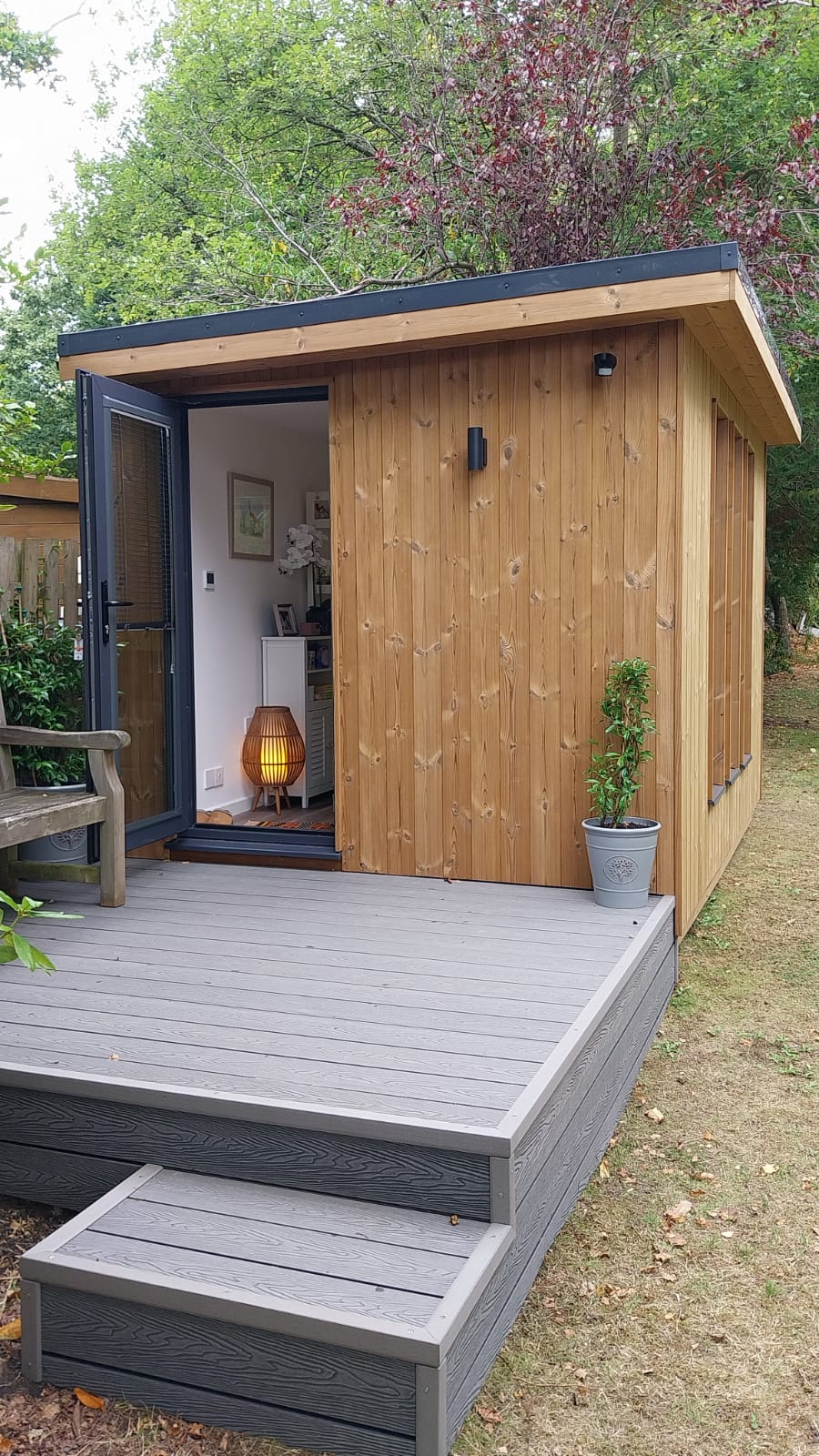 Medium sized contemporary garden studio with composite decking