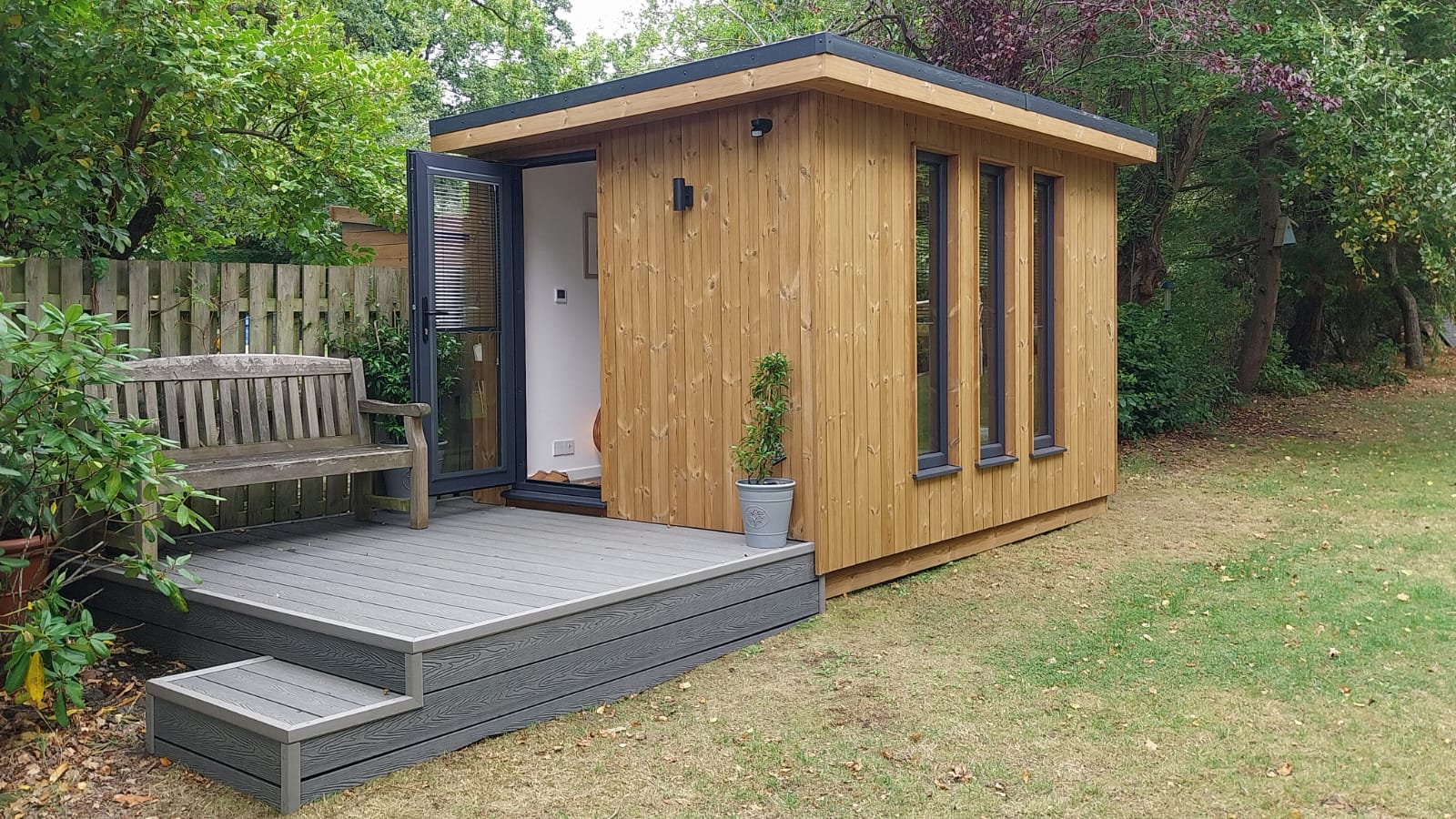 Medium sized contemporary garden studio with composite decking